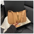 Detailed close-up of a camel leather shoulder bag with a vintage gold piston lock - Khaki