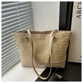 Detailed view of straw tote bag with contrast faux leather base and shoulder straps - Khaki