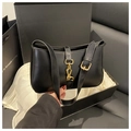 Detail showing elegant black half-moon shoulder bag with golden piston clasp on silk lining - Black