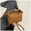 Close-up of brown woven texture mini crossbody bag with elegant gold metal clasp closure - Brown