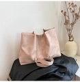 Detail of pink tote bag showing metal chain strap and rivet accents on black leather - Pink