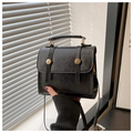 Detail of vintage black faux leather handbag with wax finish and golden round metal buckles - Black