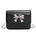 Minimalist black crossbody bag with silver bow accent and slim metal chain strap - Black