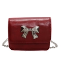 Elegant red patent leather crossbody bag with silver bow accent and chain strap - Burgundy
