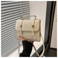 Detail of beige vintage crossbody square bag with top handle and gold round button accents - White