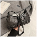 Detail of distressed grey leather bag with silver metal eyelets and punk style hardware - Black