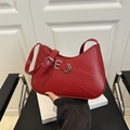 French retro red hobo bag in glossy leather with silver metal buckle held in hand - Red
