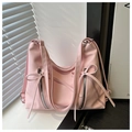 Close-up of pink tote bag featuring ribbon bows and silver metallic zipper details - Pink
