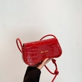 Red crocodile texture flap shoulder bag with gold lettering and knotted strap - Red