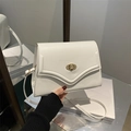 Minimalist white leather crossbody bag with elegant gold swivel lock and slim shoulder strap - White
