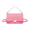 Pink crossbody bag with textured fabric flap and gold round buckle on white background - Pink