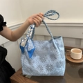 Light blue quilted tote bag with floral embroidery and silk scarf handle detail - White