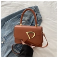 Detail of a brown leather shoulder bag with a gold D-shaped buckle and crossbody strap - Brown