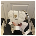 Detail of heart-shaped crossbody bag with quilted leather and golden twist lock - White