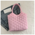 Detailed top view of a pink quilted puffer tote bag with soft embroidery on white fabric - Deep Pink