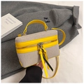 Detail of box-shaped canvas bag with bright yellow leather trim and silver metal hardware - Yellow