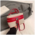Detail of box bag featuring beige canvas, red leather trim and long tassel zippers - Red