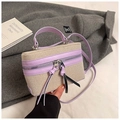 Detail of boxy beige canvas and purple leather bag with silver hardware on a grey coat - Purple