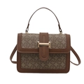 Retro monogram handbag with brown leather trim and golden clasp on white background - Brown