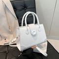 White faux leather crossbody bag with crocodile pattern and dual round handles - White