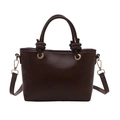 Dark brown leather bucket bag with FASHION embossment and knotted handle on white background - Brown