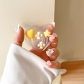 Nahaufnahme der Glitzerherz-Handyhalterung mit gelbem Ballon und Gänseblümchen - Glitzer Ballon Herz