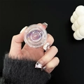Detail of transparent planet phone grip with purple nebula and glitter in hand - Purple Universe
