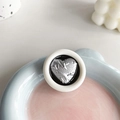 Detailed close-up of a round heart-shaped phone socket with silver metallic foil texture - Round Drip Glue Silver Foil Wrinkled Heart