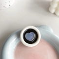 Macro shot of circular phone socket with shimmering blue heart and white outer ring - Round Drip Glue Blue Glitter Heart