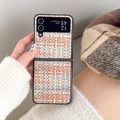 Detail of woven texture phone case for foldable device in blue and orange patterns - Brown Weaving / Samsung ZFlip3