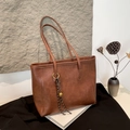 Brown large capacity bucket bag in retro faux leather with woven bell pendant - With Pendant / Brown
