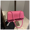 Detail view of the bright pink textured leather underarm bag with gold metal buckle - Pink