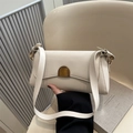 Creamy white leather baguette bag with a gold crescent buckle and a wide shoulder strap - White