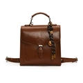 Vintage brown leather backpack with classic buckle and decorative gold bell charm - Brown With Pendant