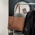 Brown litchi texture large tote bag with matching coin pouch hung on a hanger - Brown