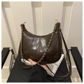 Close-up of dark brown vintage hobo bag with glossy leather and gold chain detail - Coffee