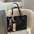 Elegant black faux leather tote bag with vintage scarf and gold fashion label detail - Black