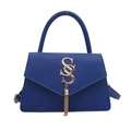 Royal blue top handle bag with gold S logo and fringe detail on white background - Blue