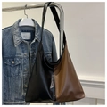 Detail of a large capacity tote bag featuring black and brown color-blocking leather - Color Block Coffee