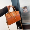 Brown leather handbag featuring a mix of smooth and crocodile pattern textures with gold S-logo - Brown