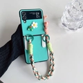 Cute green frog and flower folding phone case with a colorful woven shoulder strap - Green / Huawei Pocket 2