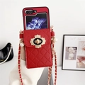 Close-up of red quilted leather phone case with gold lock and pearl chain strap - Samsung ZFlip3 / Red