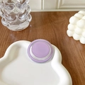 Close-up of a minimalist purple magnetic phone grip on a white ceramic cloud tray - Purple