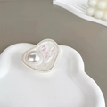 Close-up of heart-shaped phone grip featuring pearl texture and iridescent accents - Irregular Ring Stand - White Flash - Pleated Heart Pearl