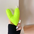 Detail of a bright neon green plush heart phone grip with a minimalist cat woven label - Warped Heart (Green)