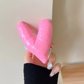 Close-up of a pink padded heart-shaped phone grip with glossy texture and small tag - Warped Heart (Rose Red)