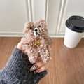 Close-up of brown plush kitten phone grip with golden bowtie and soft lamb wool texture - Khaki