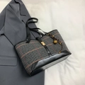 Large plaid wool tote bag with leather trim and gold twist lock shown from 45-degree angle - Black with Pendant