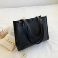 Detail of black leather tote bag with 3D embossed graffiti and golden metal rivets - Black