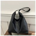 Close-up of black oversized hobo bag showing high-quality textured faux leather surface - Black